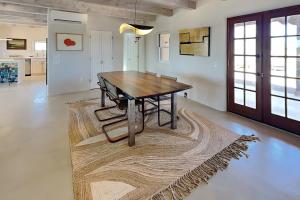 a dining room with a wooden table and a rug at Five Ravens in Santa Fe +13 photos