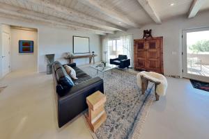 a living room with a couch and a table at Five Ravens in Santa Fe