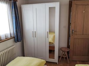 a white cabinet in a bedroom with a bed at Apartment 3 Bettwohnung by Interhome in Sils Maria +22 photos