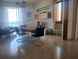 a living room with a dining room table and chairs at Marina Serra in Marina Serra