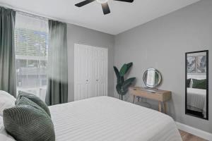 a bedroom with a bed and a ceiling fan at The Cedar Loft B - Team Joseph Ellen in St. Augustine