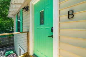 a green door on the side of a house at The Cedar Loft B - Team Joseph Ellen in St. Augustine