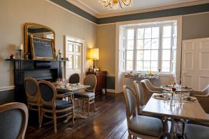 a restaurant with tables and chairs and a mirror at Corrib House Guest Accommodation in Galway