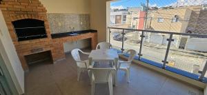 a dining room with a table and chairs and a fireplace at Apartamento da Dani in Guaratinguetá +14 photos