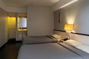a hotel room with two beds and a window at Hotel Camino Real Valera in Valera +8 photos