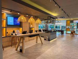 a large room with a table with a laptop on it at ibis Canoas Shopping in Canoas +24 photos