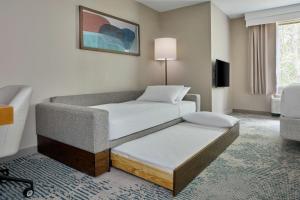 a living room with a bed and a couch at SpringHill Suites by Marriott Atlanta Alpharetta in Alpharetta