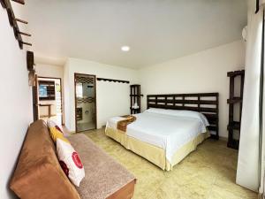 a bedroom with a bed and a couch at The Rock House Eco in San Andrés