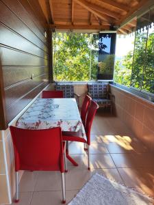 a table and chairs on the porch of a house at Umut Konaklama in Ardeşen