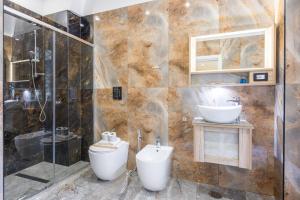 a bathroom with a toilet and a sink at Partenope Rooms in Naples +9 photos