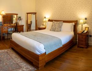a bedroom with a large bed and a desk at Corrib House Guest Accommodation in Galway