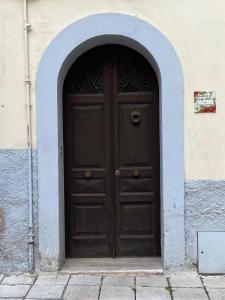 a large wooden door in a building with an arch at Dimora al Borgo Antico in Isernia