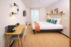 a bedroom with a bed and a desk with a computer at Hife Bordeaux in Bordeaux +48 photos