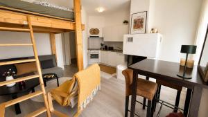 a room with a dining table and a bunk bed at Petit Canada - Studio à louer in Champex +8 photos