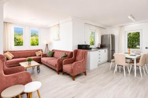 a living room with two couches and a kitchen at Daisy Villa in Dalyan