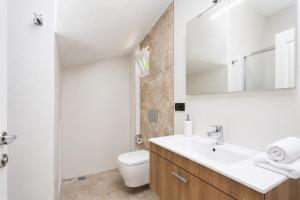 a bathroom with a sink and a toilet and a mirror at Daisy Villa in Dalyan +16 photos