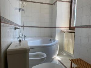 a bathroom with a tub and a toilet and a sink at Dimora al Borgo Antico in Isernia