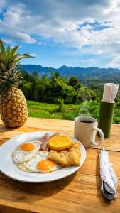 a plate of eggs and a cup of coffee on a table at Finca Mirador De Gualaca in Gualaca