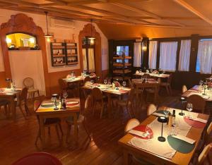 a restaurant with tables and chairs in a room at Hotel Liberty in Pattada +11 photos