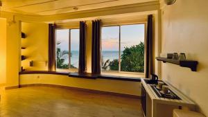 a room with a large window with a view of the ocean at White Maakana Lodge Maldives - all inclusive ed escursioni incluse ogni giorno in Felidhoo  +228 photos