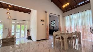 a dining room with a table and chairs at Villa Tropical Oasis in Balapitiya