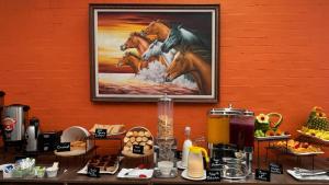 a painting of three horses on a wall at Hotel Regency Boutique La Feria in Bogotá