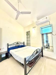 a hospital room with a bed and a ceiling fan at Aashiayana Villa - The Dream Stays ll Big Pvt Pool ll 3 Ac rooms ll Wi-fi in Lonavala
