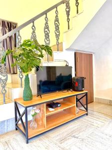 a living room with a tv on a table at Aashiayana Villa - The Dream Stays ll Big Pvt Pool ll 3 Ac rooms ll Wi-fi in Lonavala