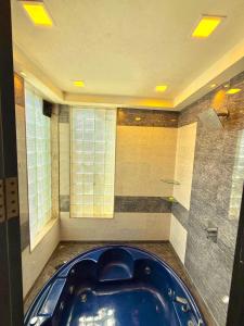 a bathroom with a blue tub in a room at Aashiayana Villa - The Dream Stays ll Big Pvt Pool ll 3 Ac rooms ll Wi-fi in Lonavala +28 photos