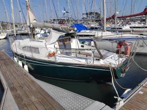 a boat is docked at a dock with other boats at Face à la Mer in Perros-Guirec