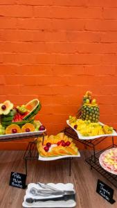 three trays of different types of fruit on display at Hotel Regency Boutique La Feria in Bogotá +29 photos