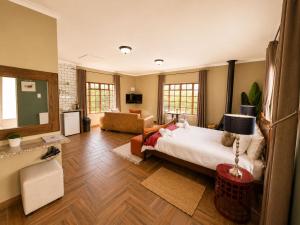 a bedroom with a bed and a living room at Amber Collection in Dullstroom