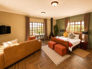a hotel room with a bed and a couch at Amber Collection in Dullstroom