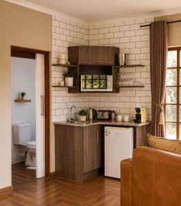 a kitchen with a sink and a refrigerator at Amber Collection in Dullstroom +52 photos