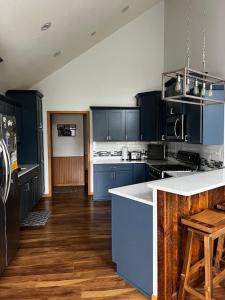 a kitchen with blue cabinets and a white counter top at The Fairway Escape in Hayward