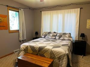 a bedroom with a bed and a window at The Fairway Escape in Hayward