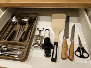 a drawer filled with kitchen utensils in a cabinet at BARI SOUL old town in Bari +8 photos