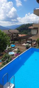 a large blue swimming pool in a building at La Terrazza Casa Vacanza in Carenno