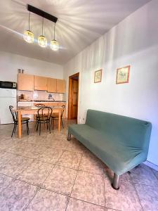 a living room with a couch and a kitchen at Bentu e Soli Home Holiday in Villasimius +16 photos