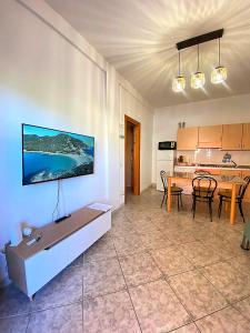 a living room with a table and a dining room at Bentu e Soli Home Holiday in Villasimius
