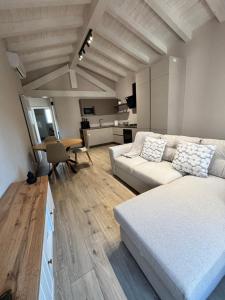 a living room with a white couch and a table at Casa LEONARDO in CastellʼArquato
