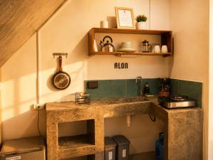a kitchen with a large stone sink in a room at Hiraya Apartments in San Vicente