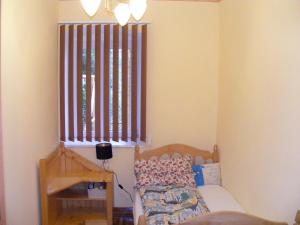 a small bedroom with a bed and a window at Négy Gólya in Sarud