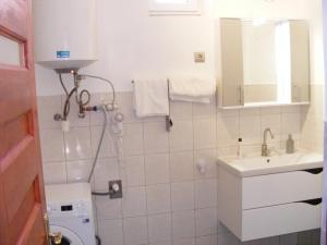 a bathroom with a toilet and a sink at Négy Gólya in Sarud +14 photos