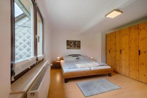 a bedroom with a bed and a large window at Ferienwohnung Sensweiler Mühle in Sensweiler