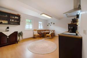 a kitchen and dining room with a table in it at Ferienwohnung Sensweiler Mühle in Sensweiler