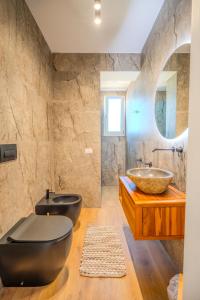 a bathroom with two sinks and a large mirror at Tenuta Bruni - Agriturismo & Pool in Squinzano +41 photos
