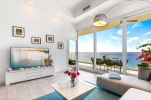 a living room with a large aquarium and a large window at Lighthouse Point Residences in West Bay
