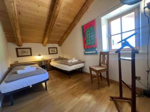 a room with two beds and a window at Chalet Monciòn in Rualp