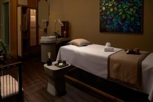 a bedroom with a bed and a sink and a mirror at Sunrise Pool Villa Cam Ranh in Cam Ranh